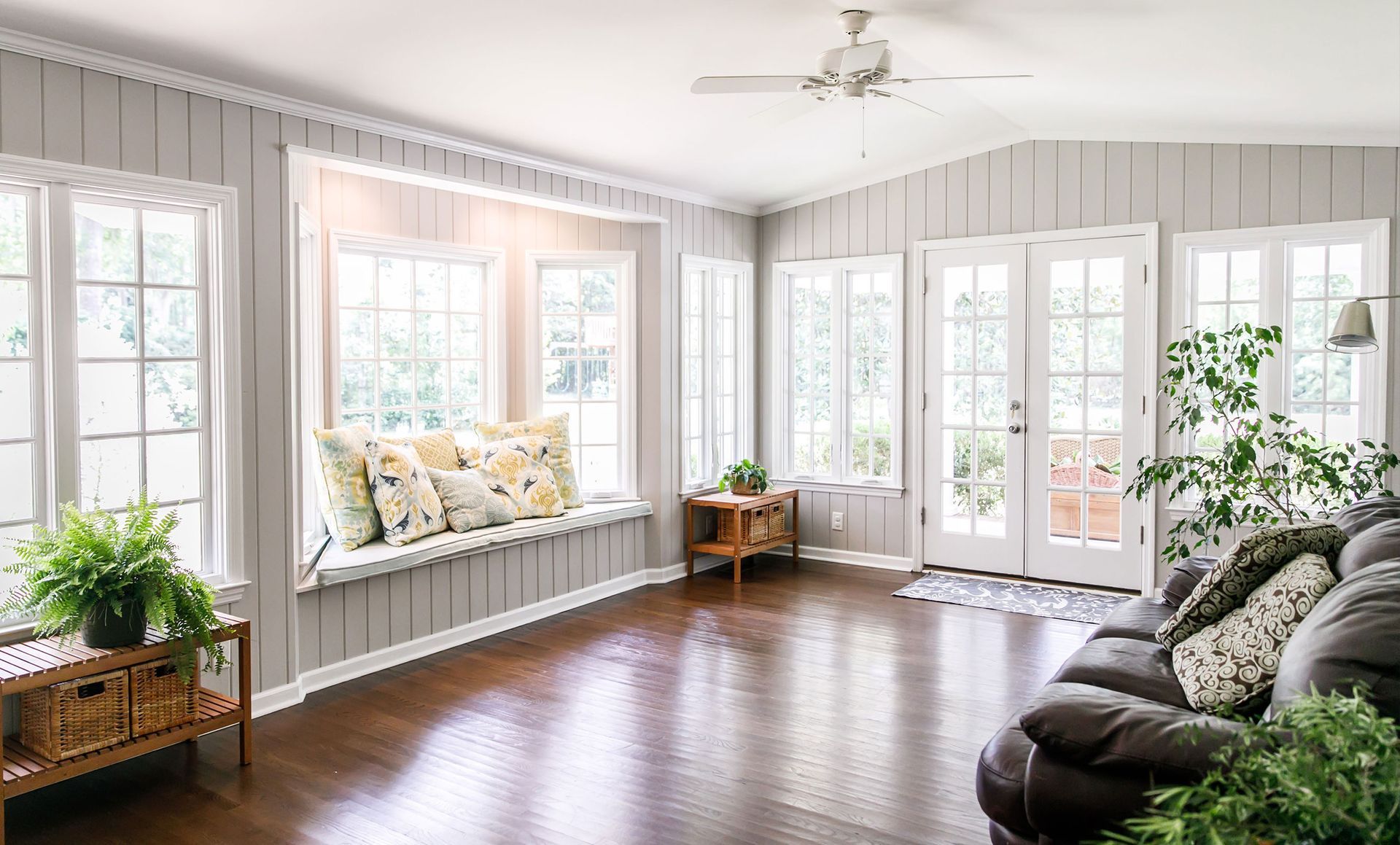A living room with a couch and a window seat