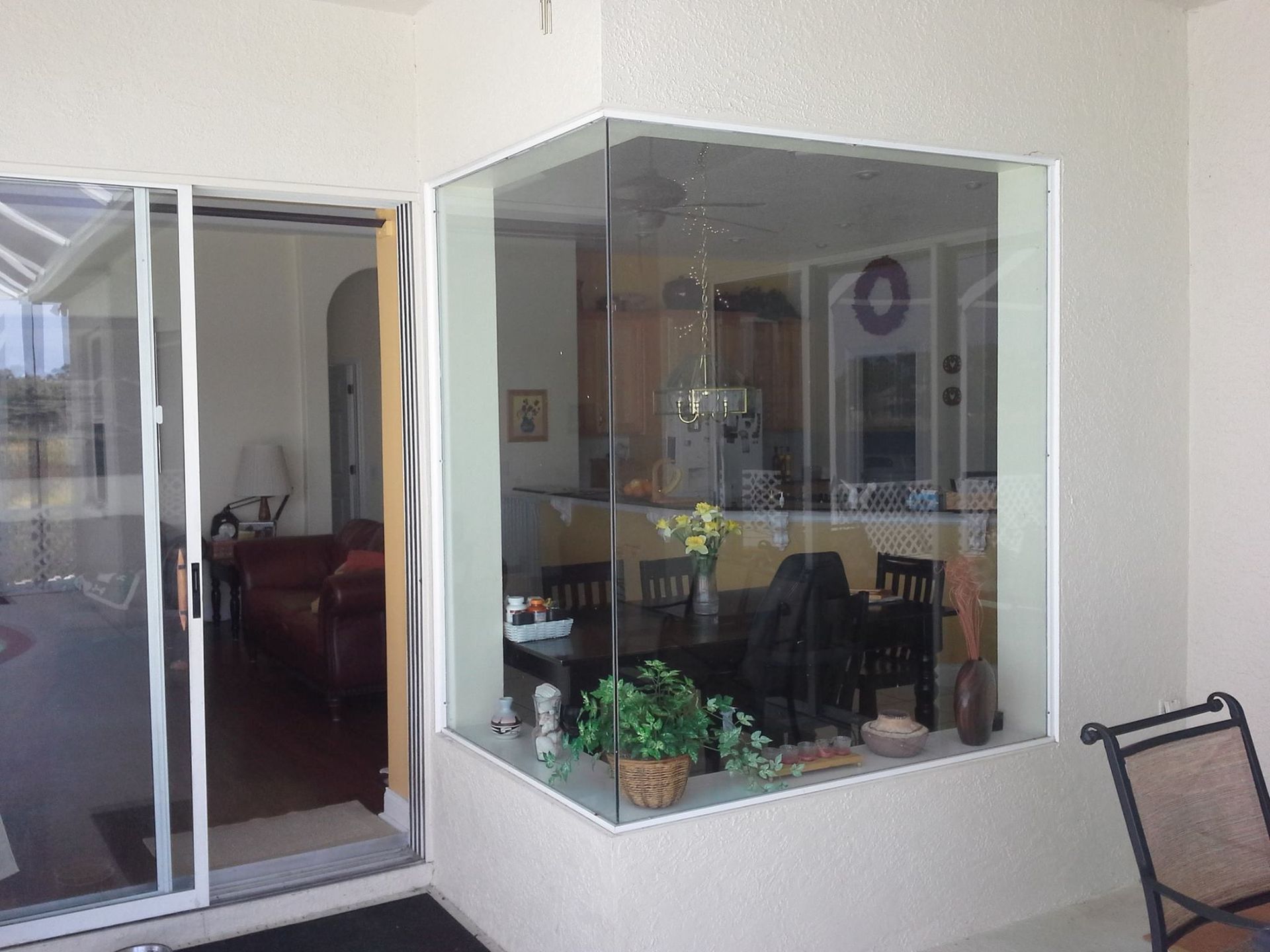 A room with a sliding glass door and a large window