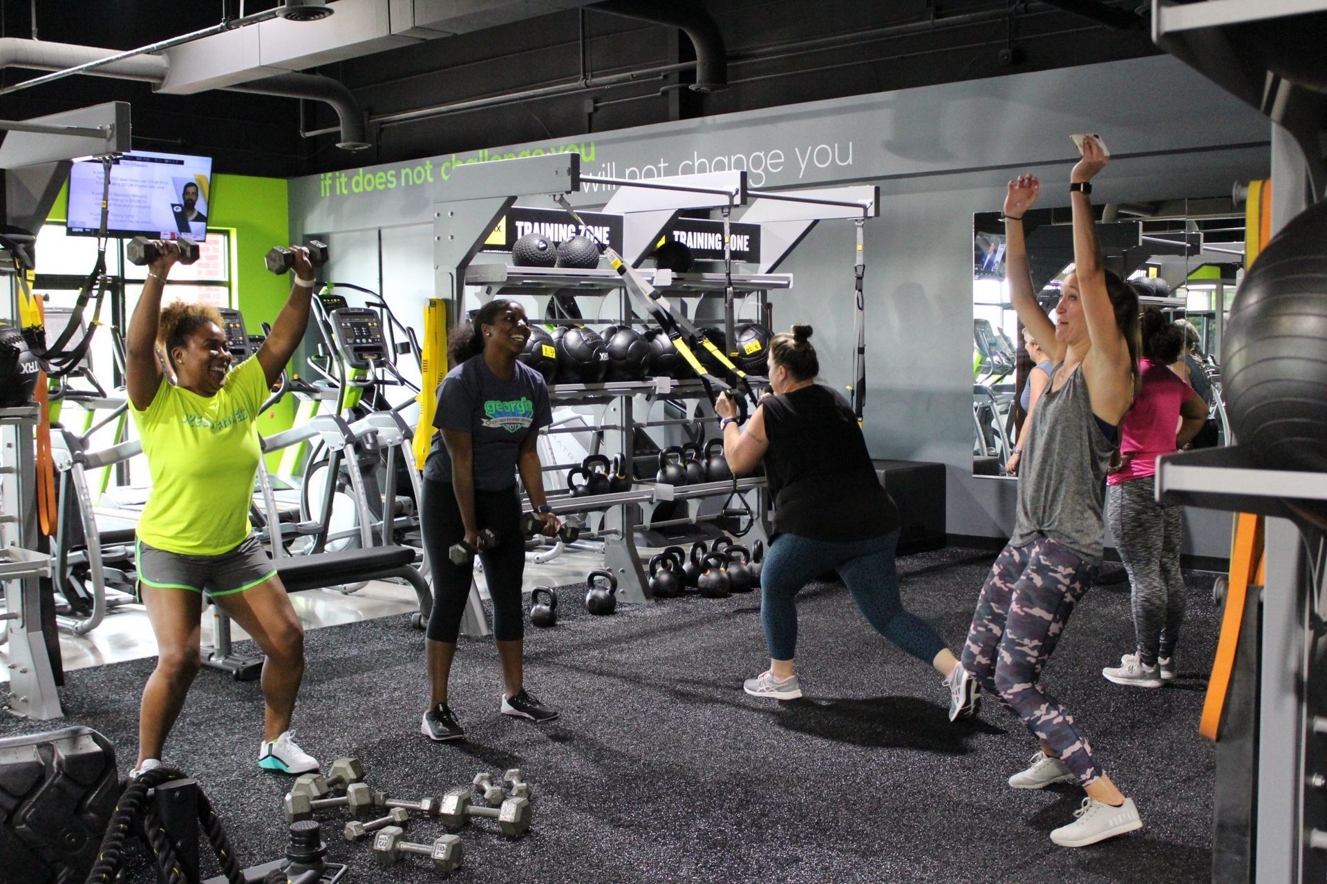 A group of women are doing exercises in a gym.