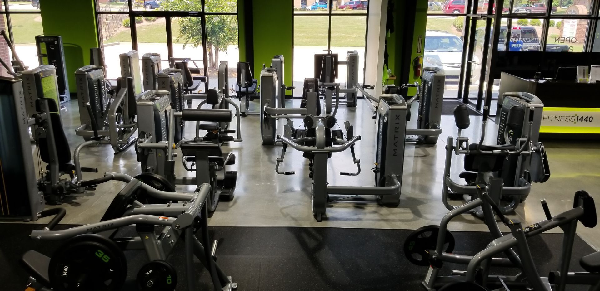 A large gym filled with lots of exercise equipment.