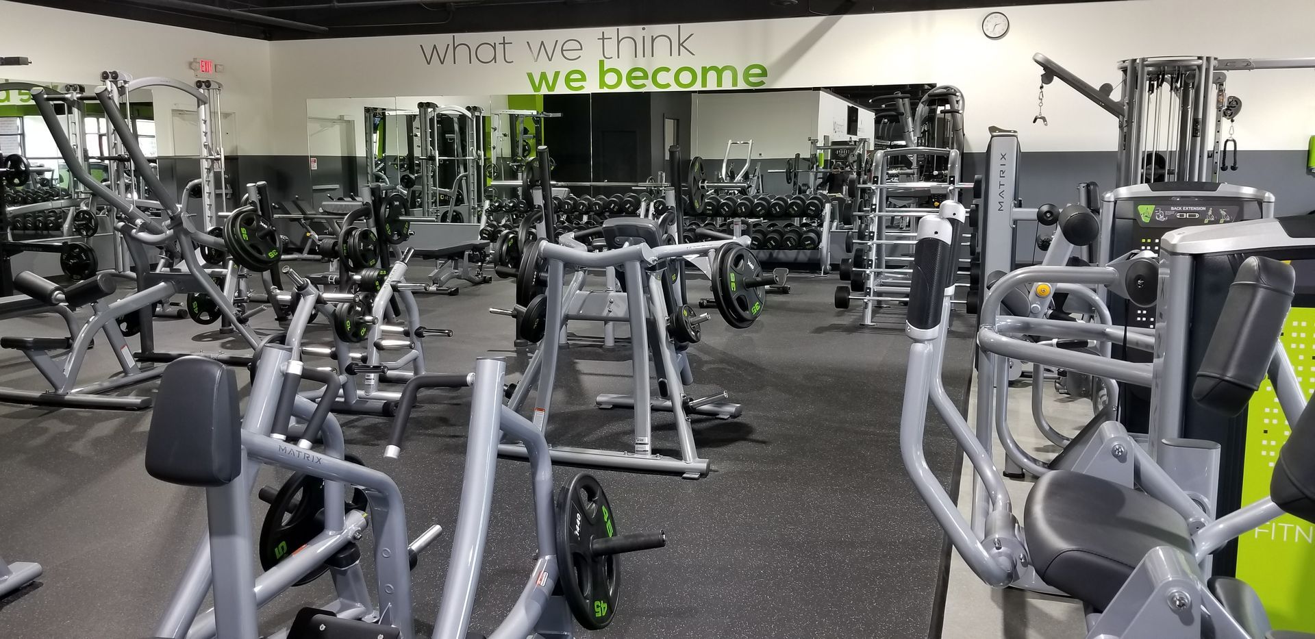 A gym filled with lots of exercise equipment and a sign that says