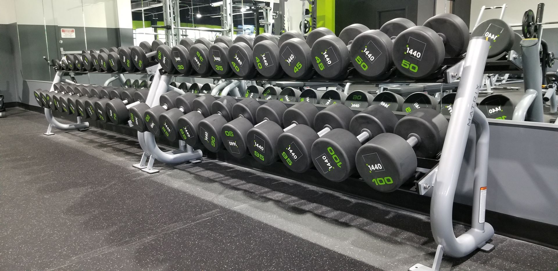 A row of dumbbells stacked on top of each other in a gym.