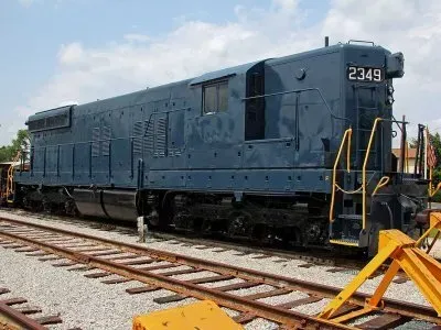 Blue locomotive numbered 2349 on railroad tracks under a partly cloudy sky