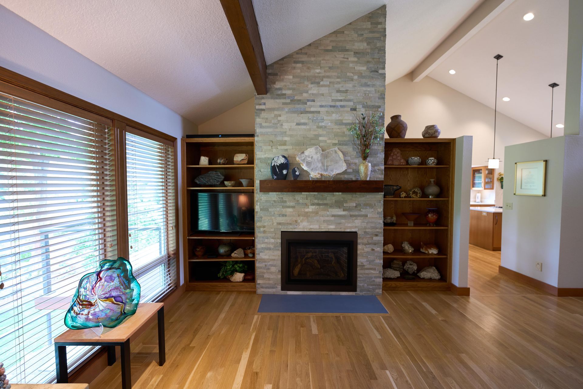 A cozy living room featuring a warm fireplace, inviting seating, and soft lighting for a comfortable atmosphere.