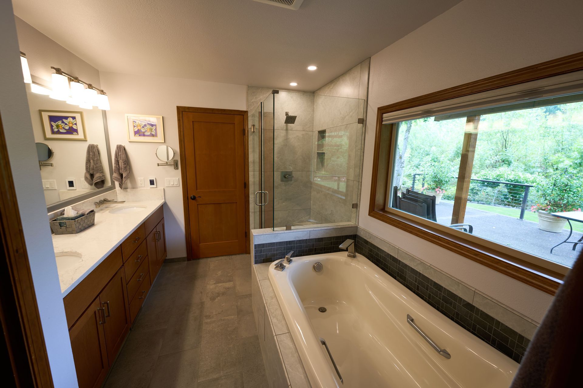 A modern bathroom featuring a spacious bathtub alongside a sleek shower, showcasing elegant design and functionality.