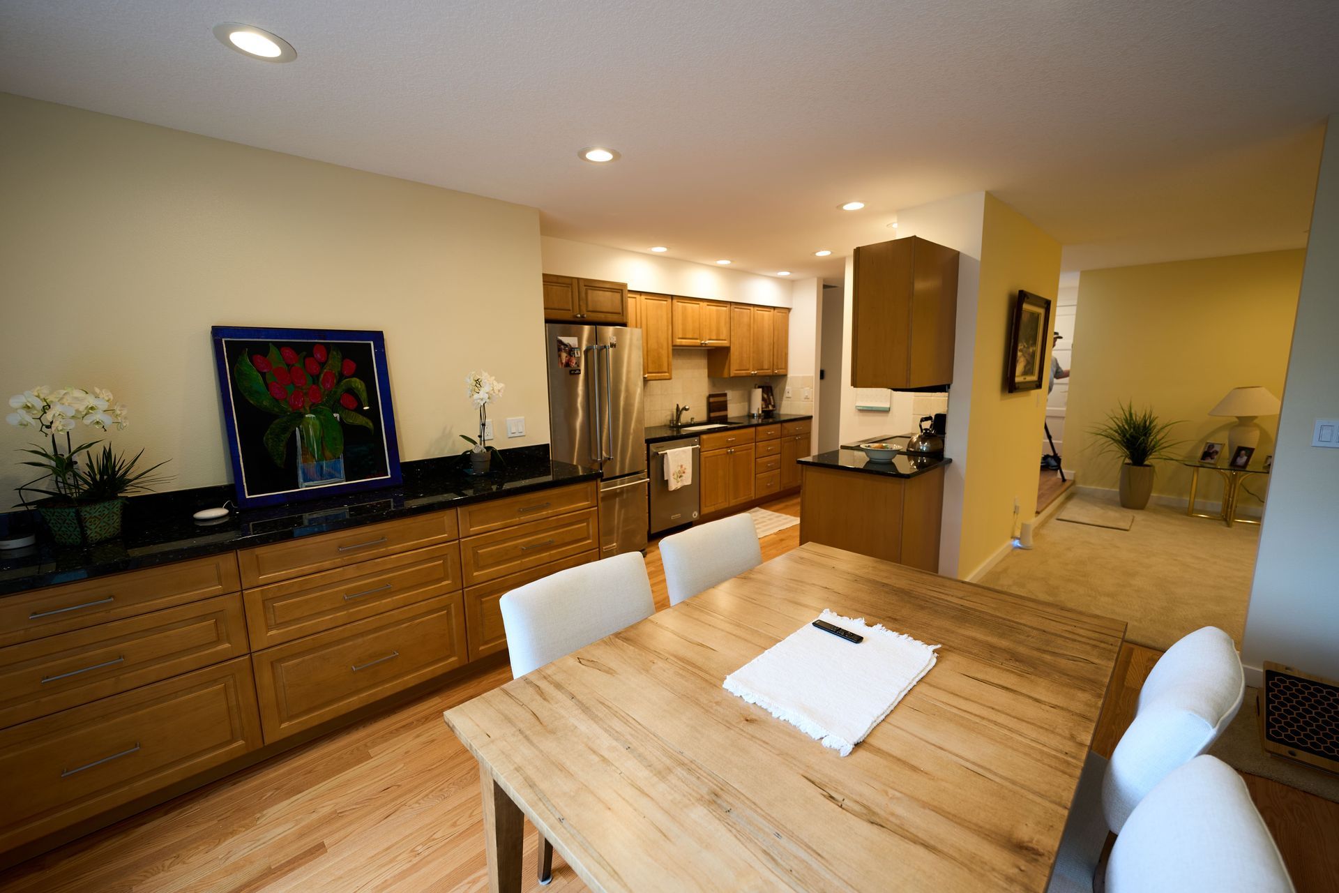 A kitchen with a table and chairs in it