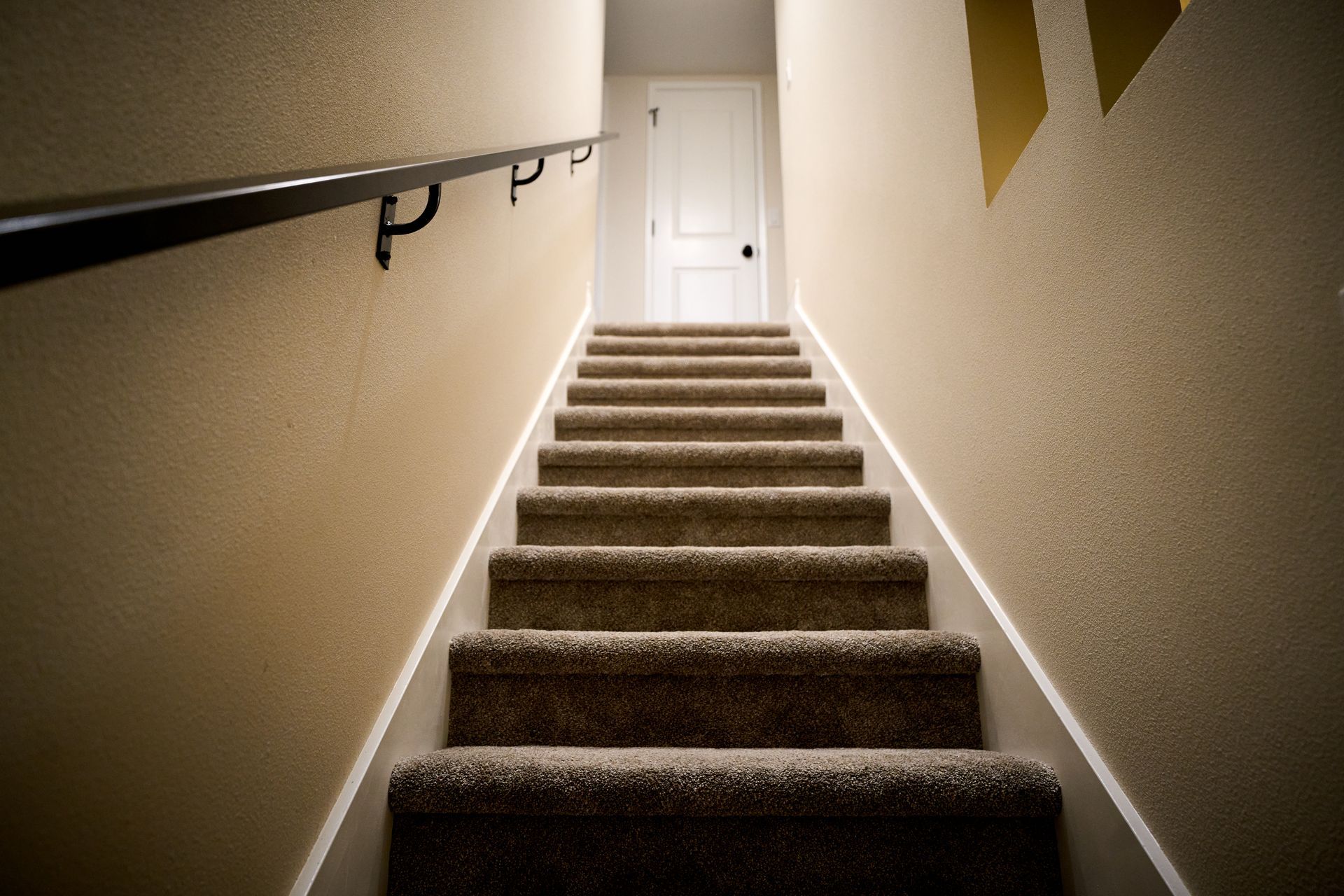 A set of stairs leading up to a door in a house.