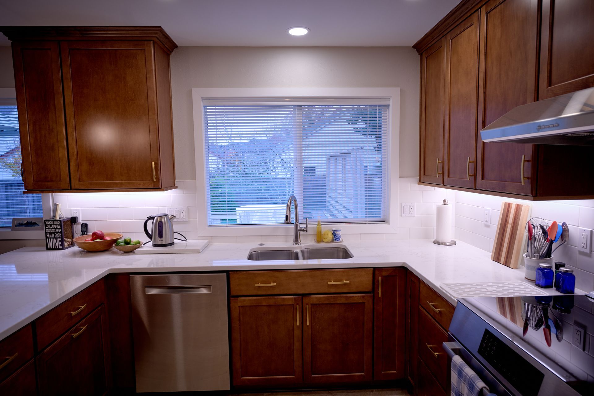 A kitchen with stainless steel appliances and wooden cabinets.