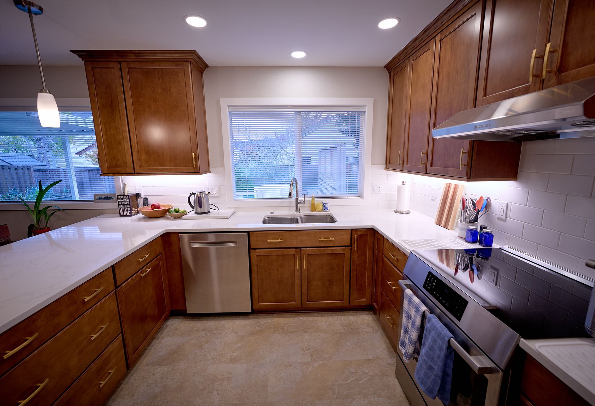 A kitchen with stainless steel appliances and wooden cabinets.