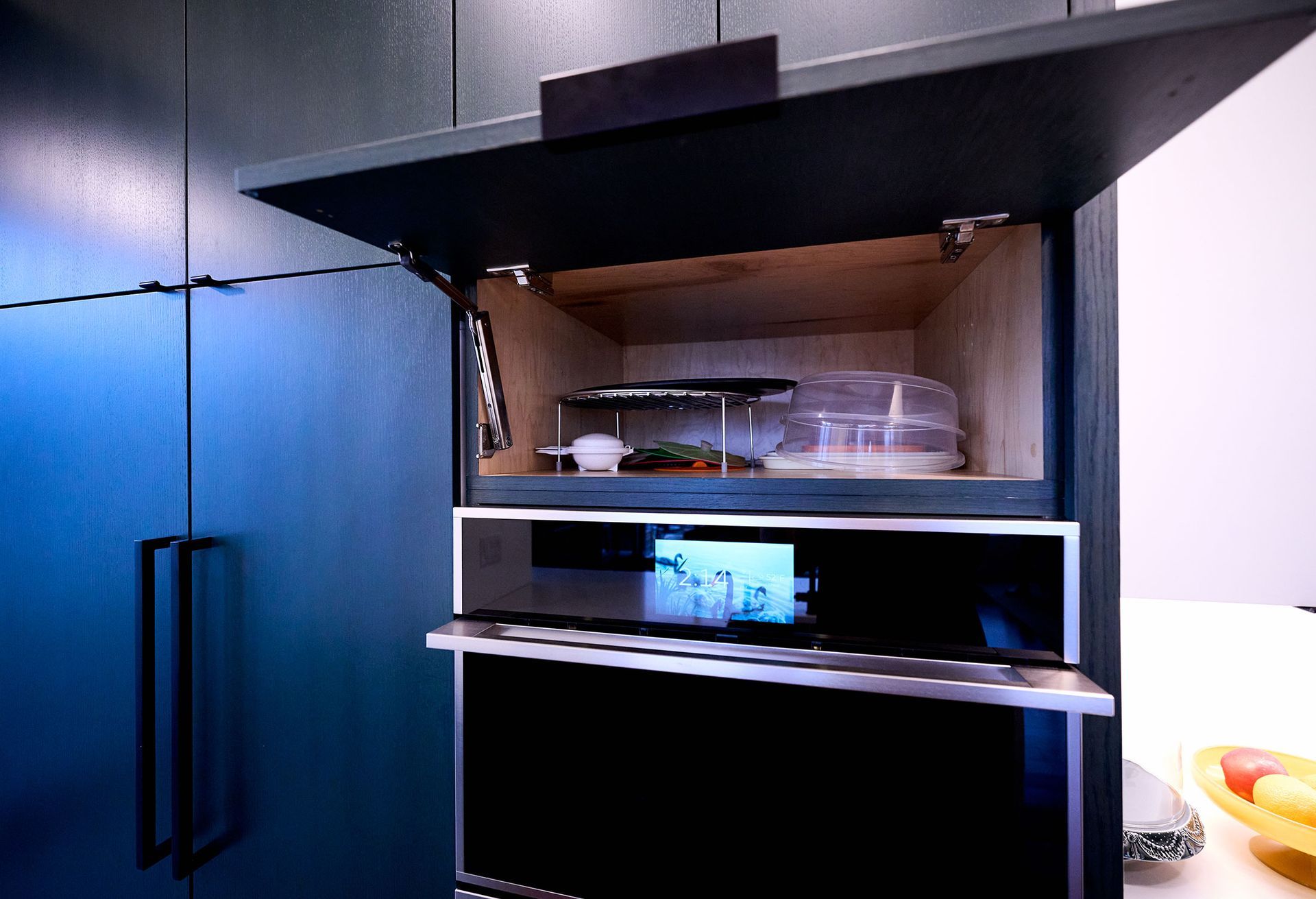 A black oven with the door opens in a kitchen.