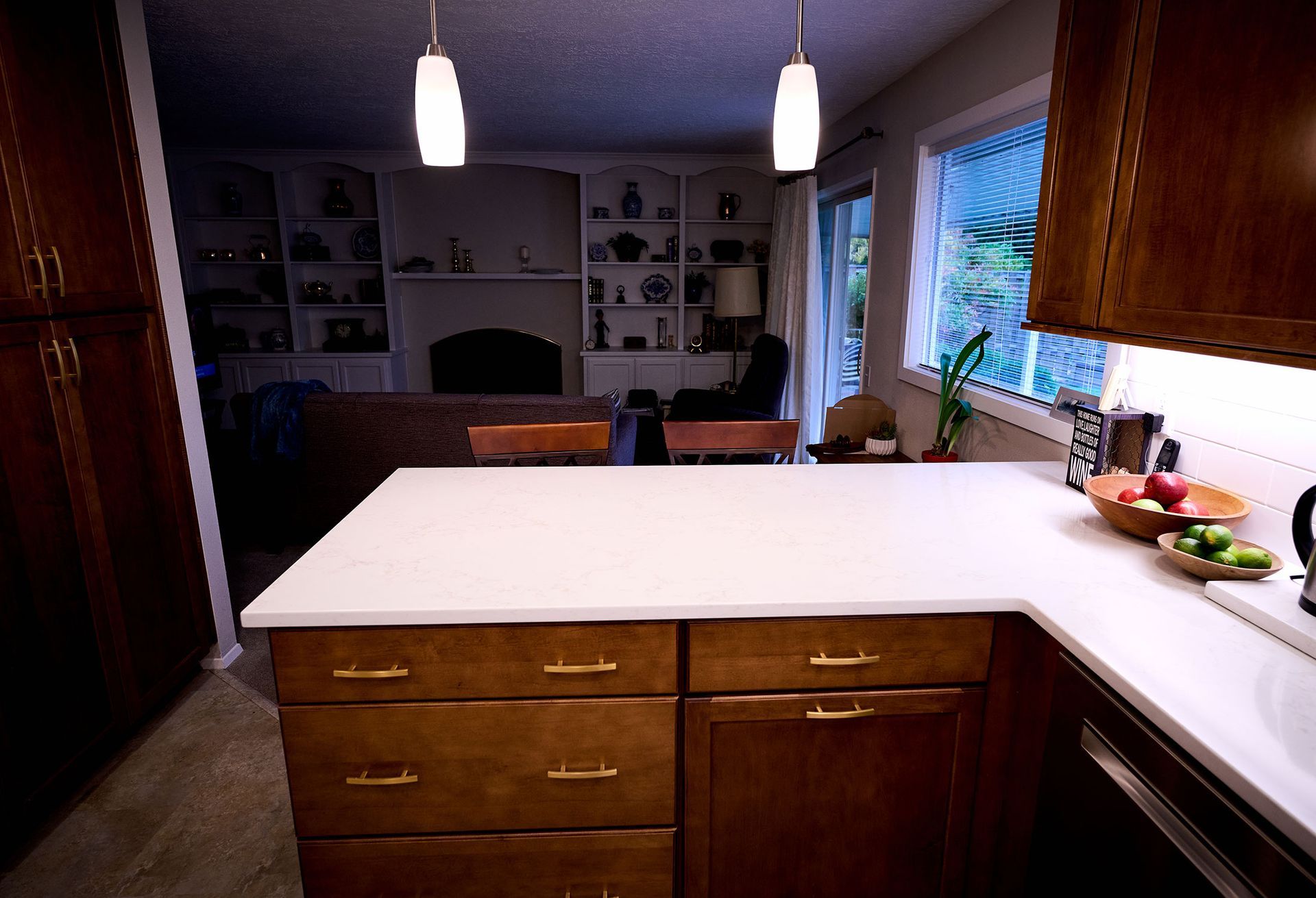 A kitchen with wooden cabinets and a white counter top .