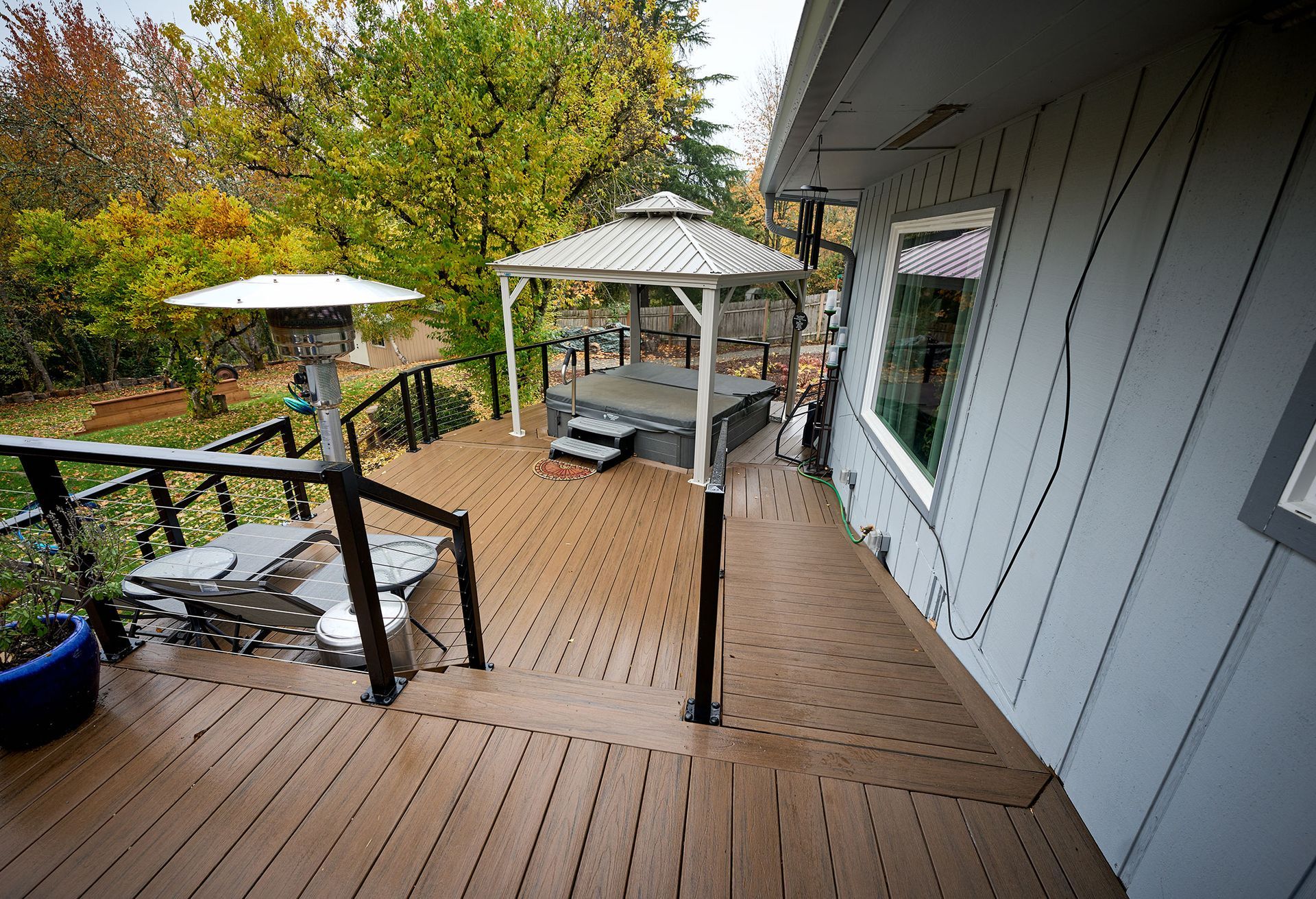 A wooden deck with a gazebo on top of it.