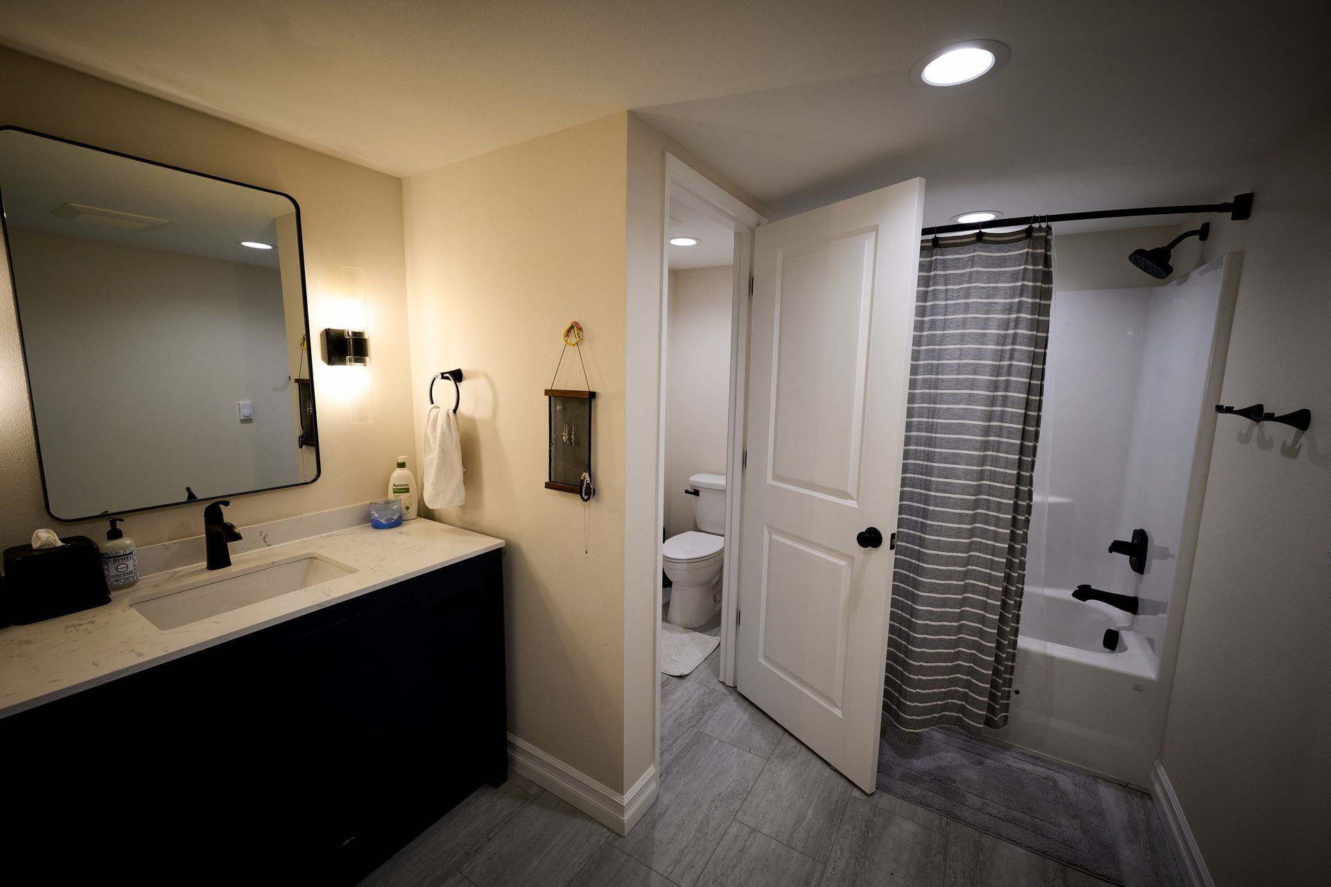 A bathroom with a sink, toilet, shower and bathtub.