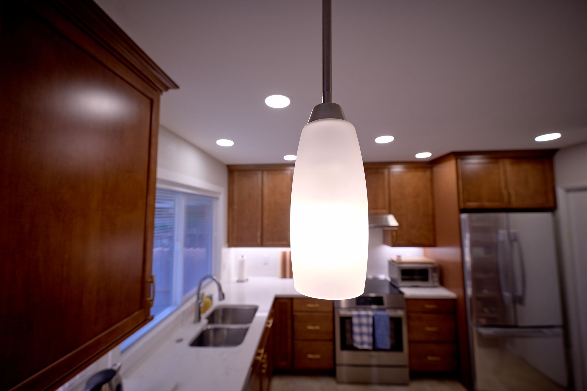 A kitchen with a light hanging from the ceiling.