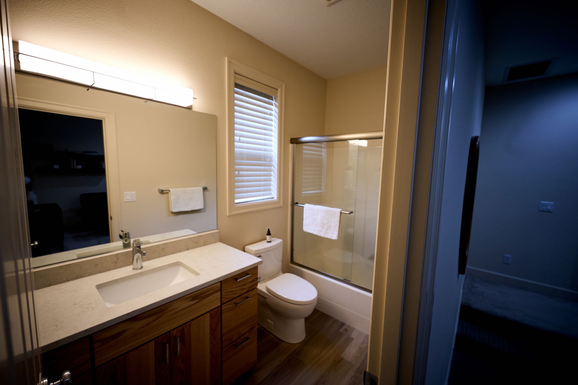 A bathroom with a toilet, sink, and shower.