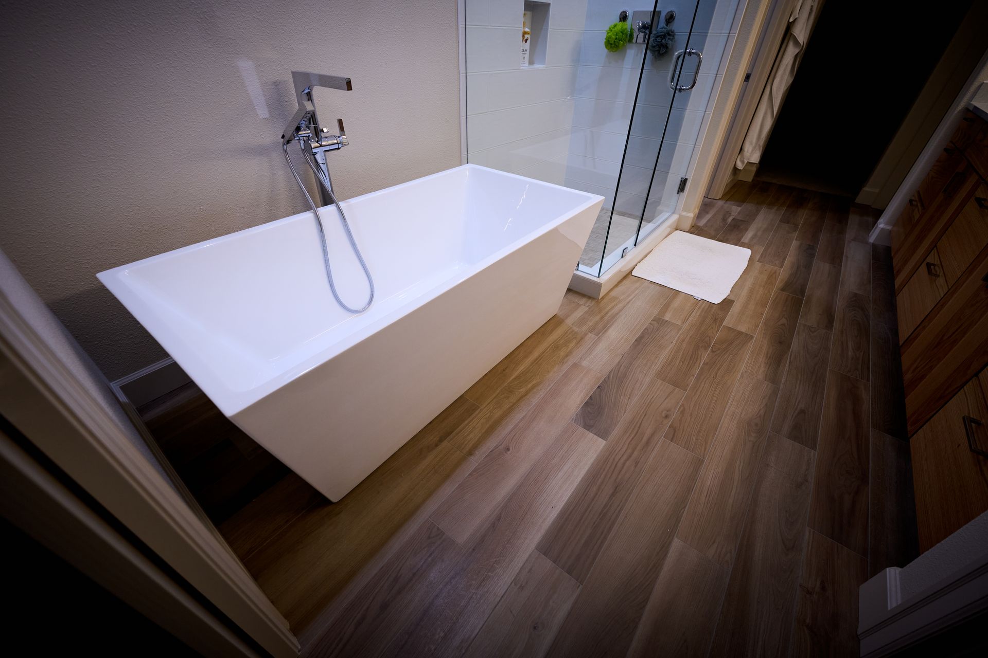 A bathroom with a bathtub and a walk in shower.