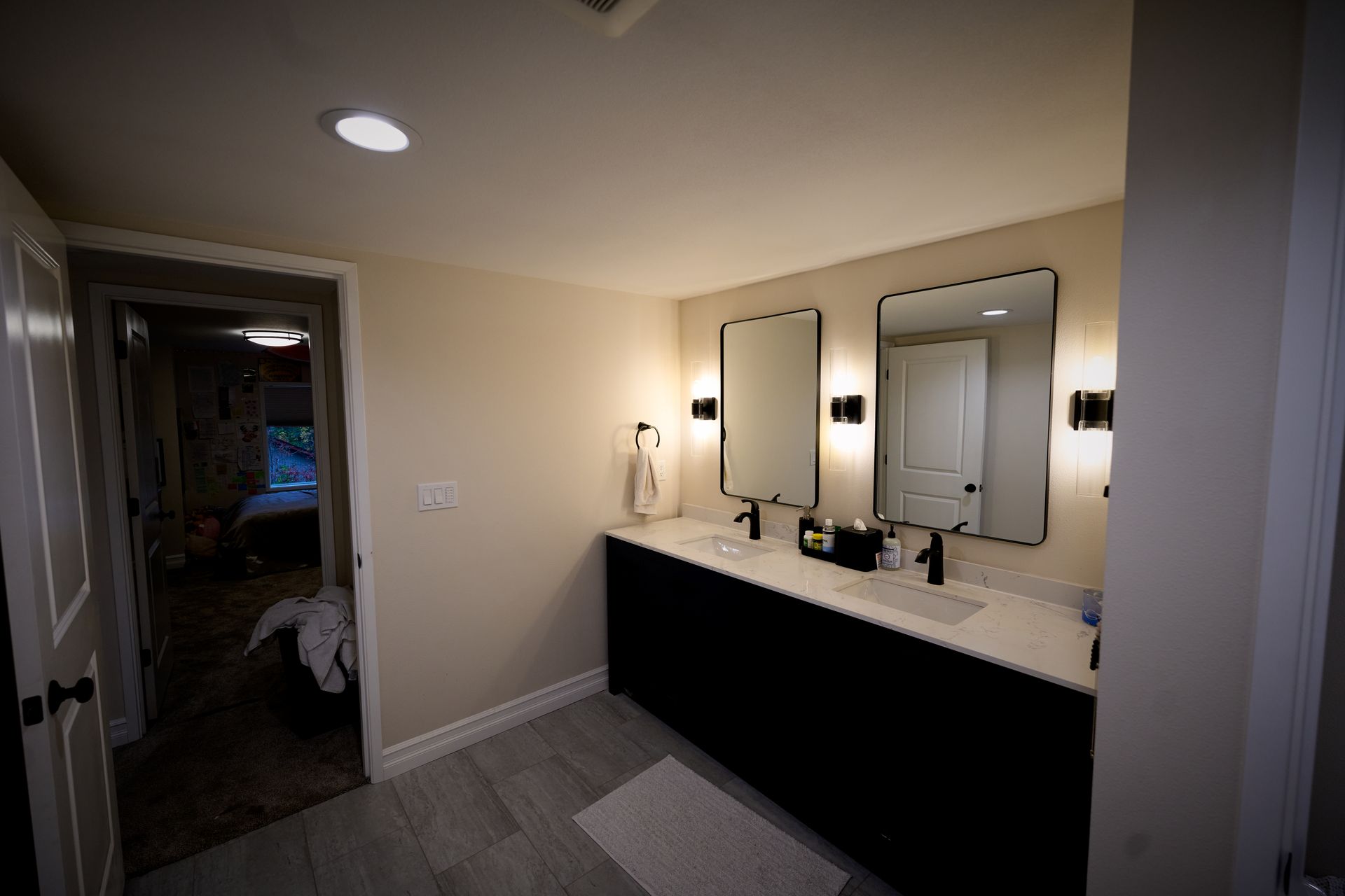 A bathroom with two sinks and two mirrors.