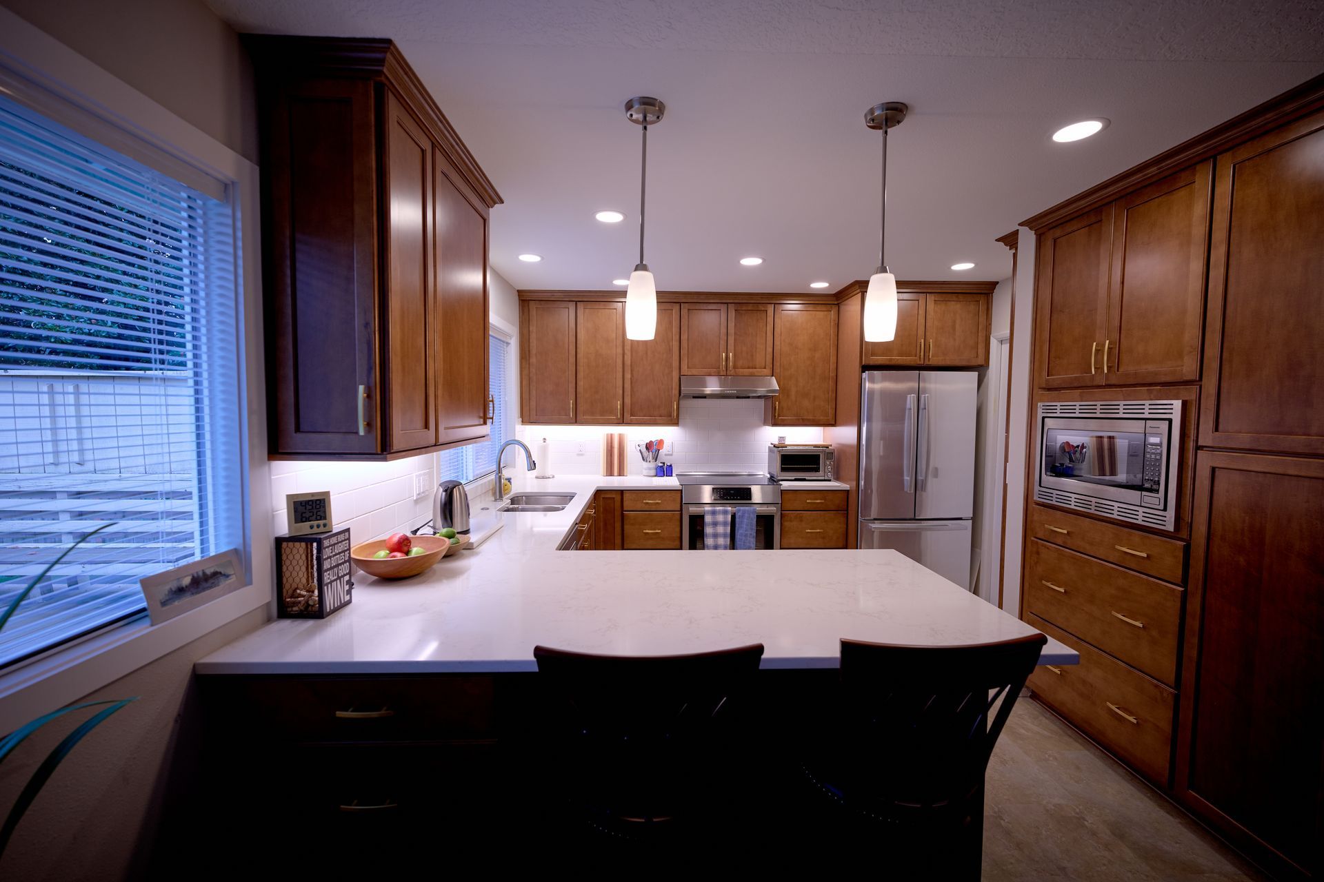 A kitchen with wooden cabinets and stainless steel appliances.