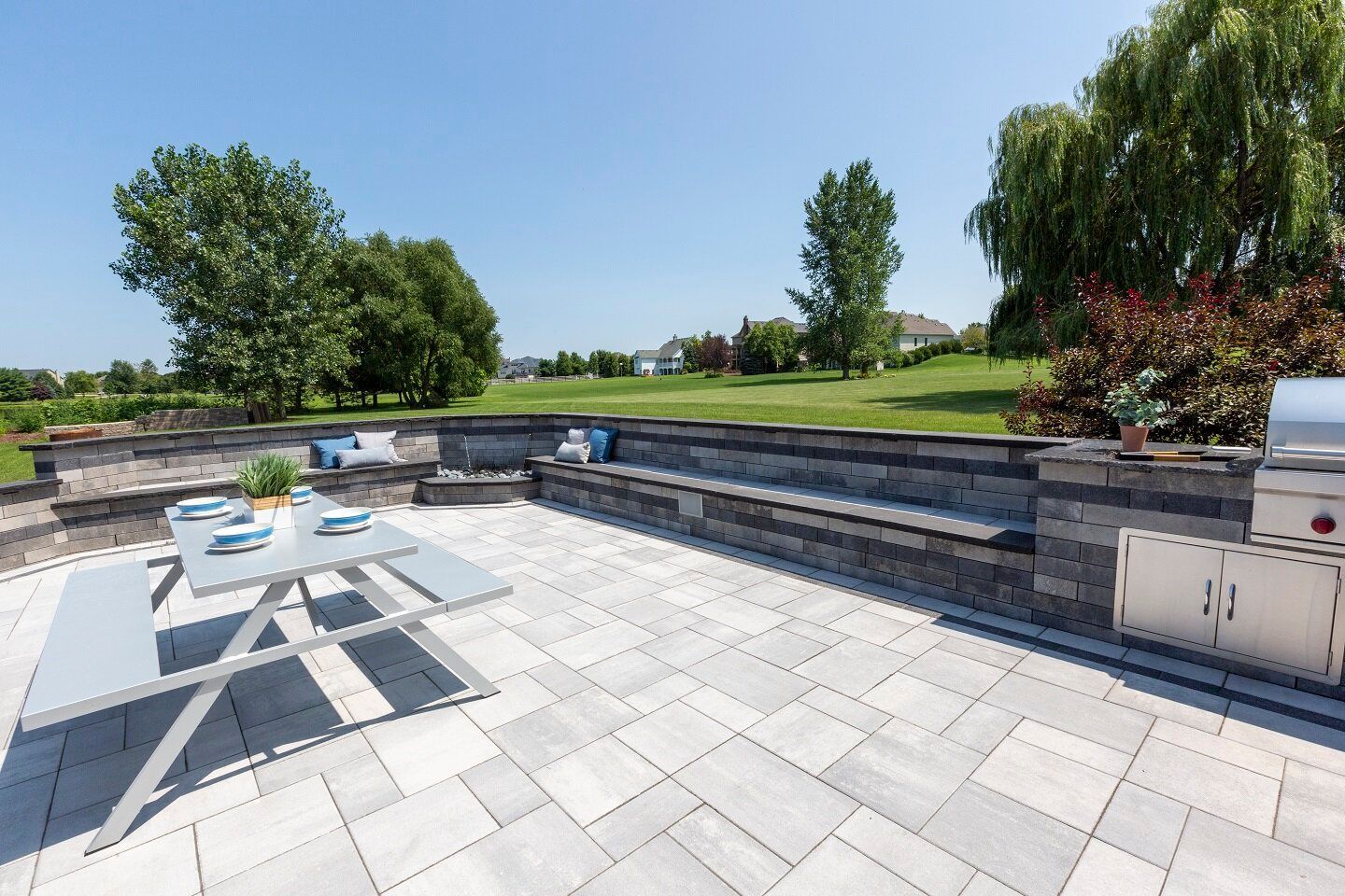 there is a picnic table and a grill on the patio
