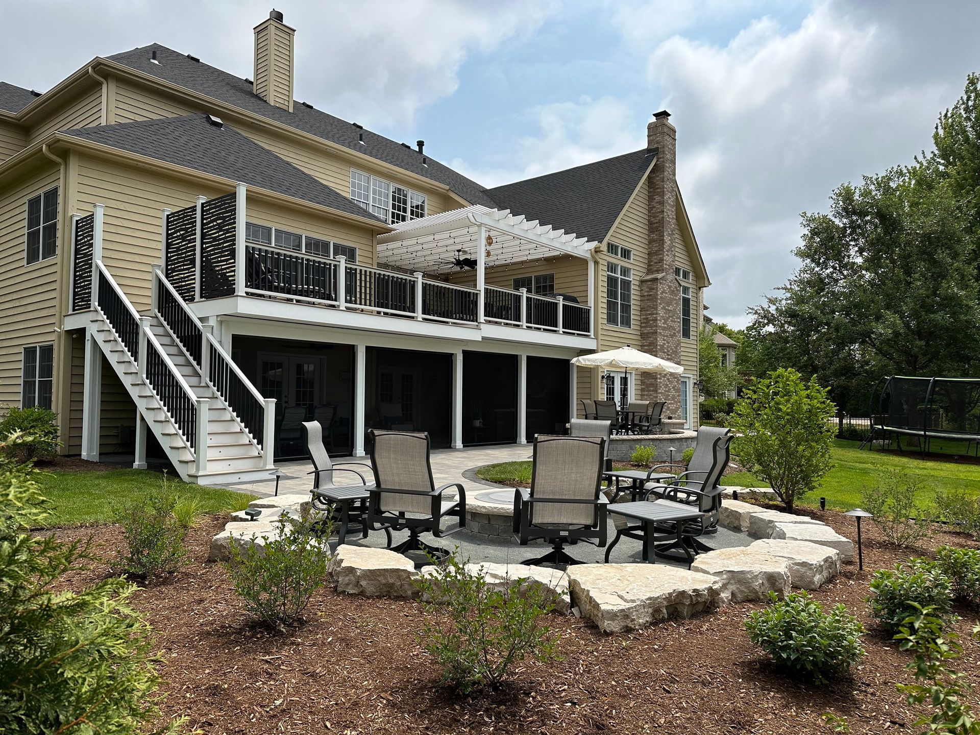 a large house with a patio area in front of it