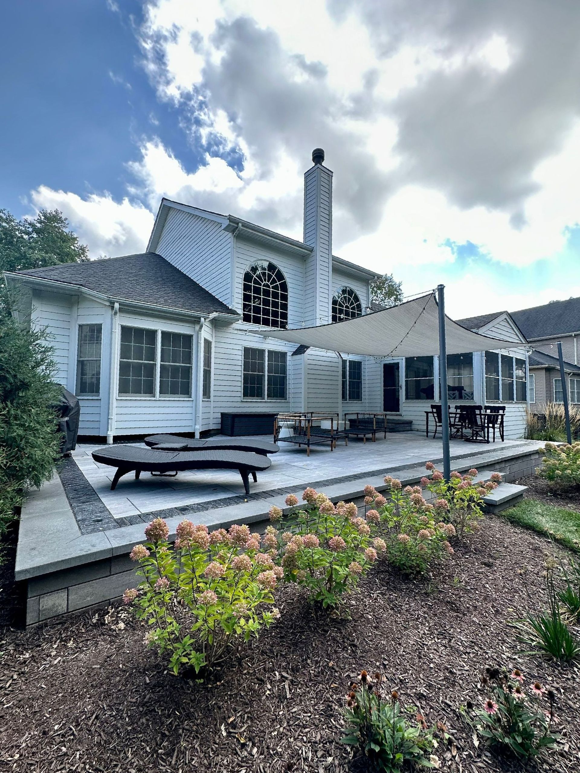 a large white house with a patio and a canopy