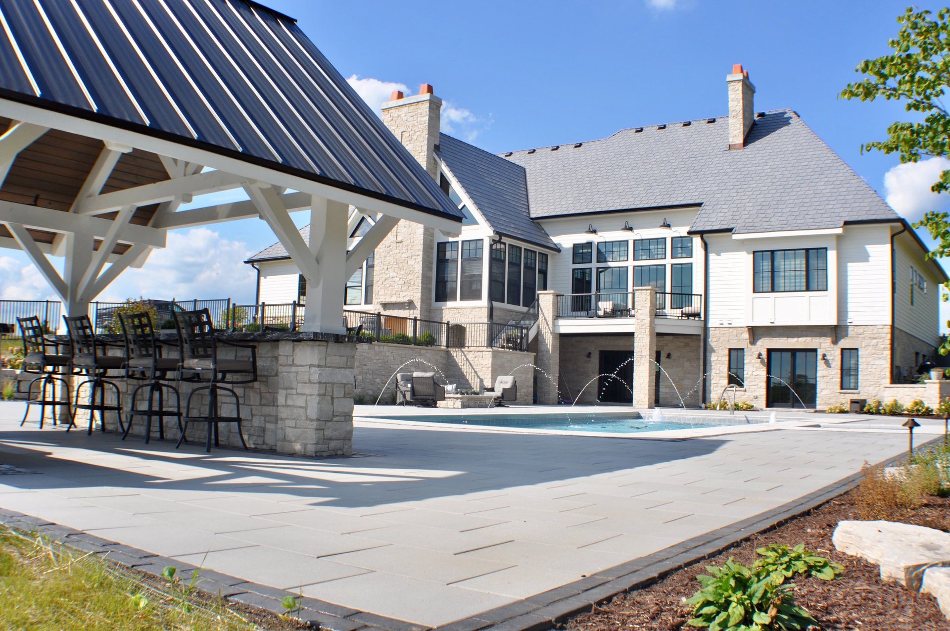 a large house with a large swimming pool in front of it