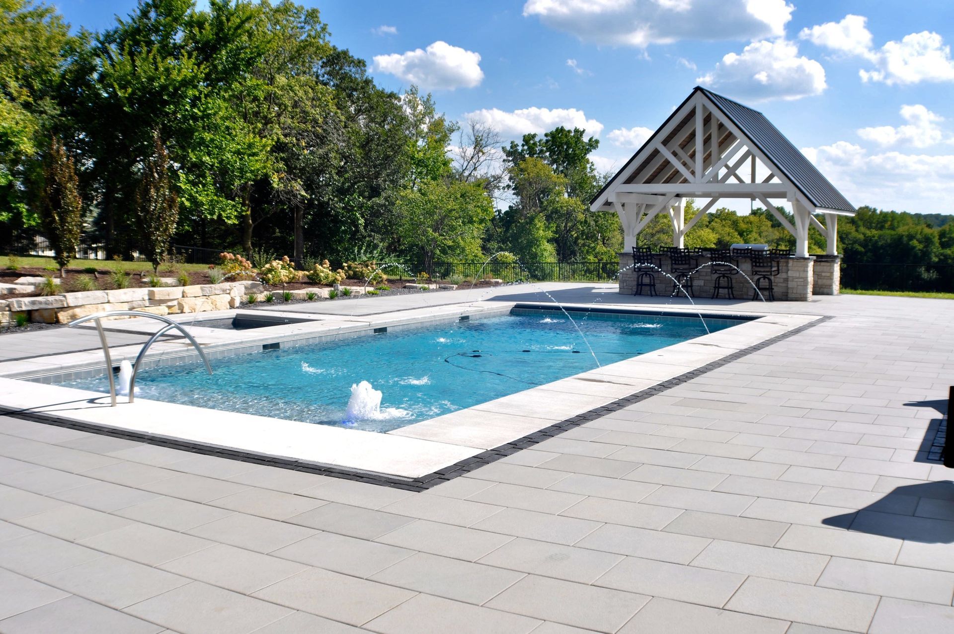 a large swimming pool with a gazebo in the background