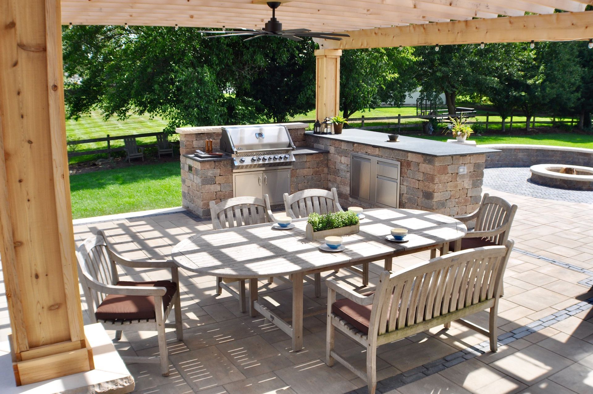 a patio with a table and chairs under a pergola