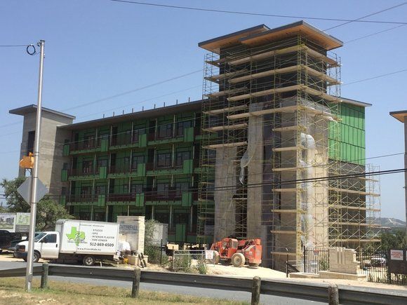 A large building is being built with scaffolding around it.