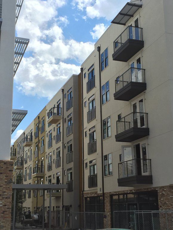 A row of apartment buildings with balconies on a sunny day