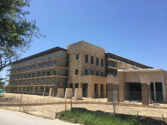 A large building is being built on a sunny day.
