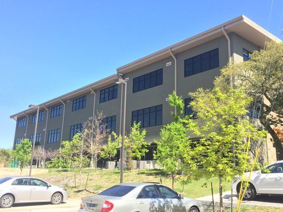A large building with cars parked in front of it