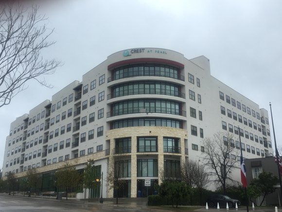 A large building with a lot of windows on a cloudy day