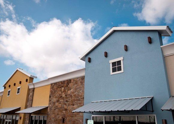 A blue and yellow building with a blue sky in the background