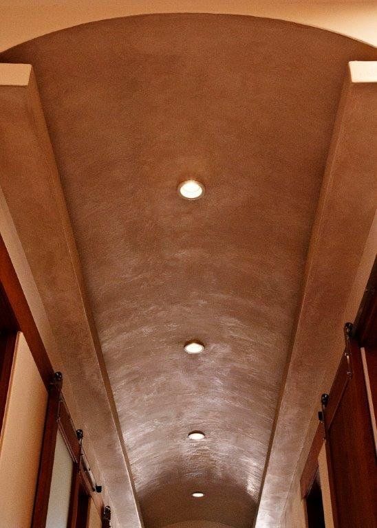 Looking up at the ceiling of a hallway with arches