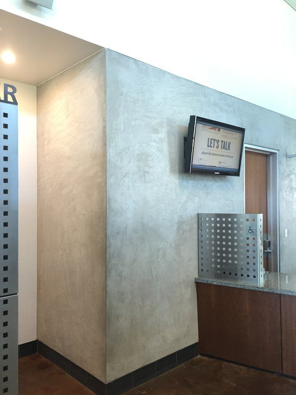 A corner of a room with a sign on the wall that says
