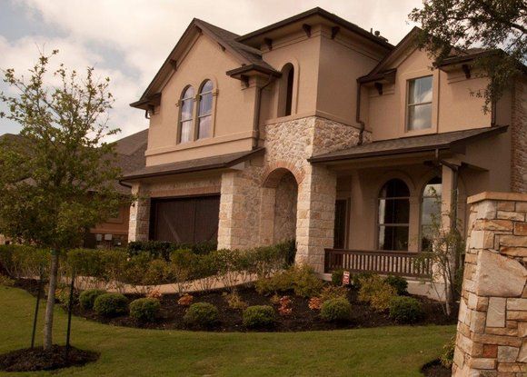 A large house with a lush green lawn in front of it