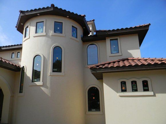 A large house with a tower and arched windows