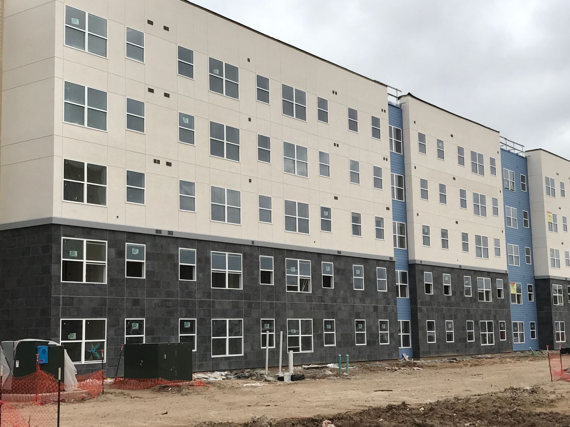 A large building with a lot of windows is under construction.