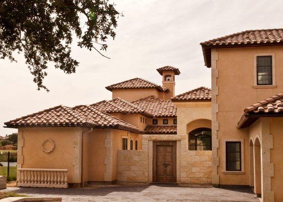 A large house with a tiled roof and arched windows
