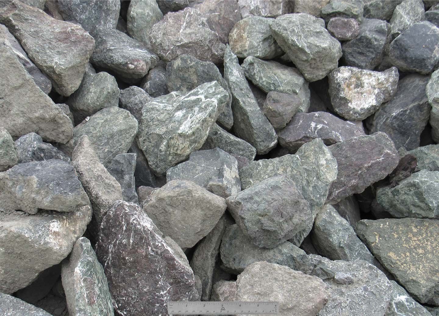 Orange tile roof with a skylight and a red ventilation pipe.