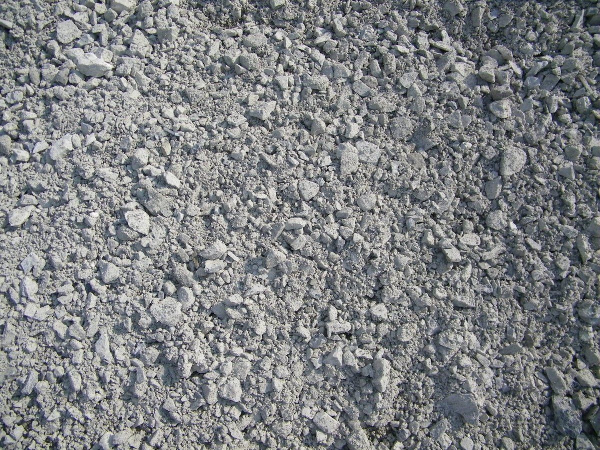 Gray crushed gravel, closely packed, creating a textured surface.