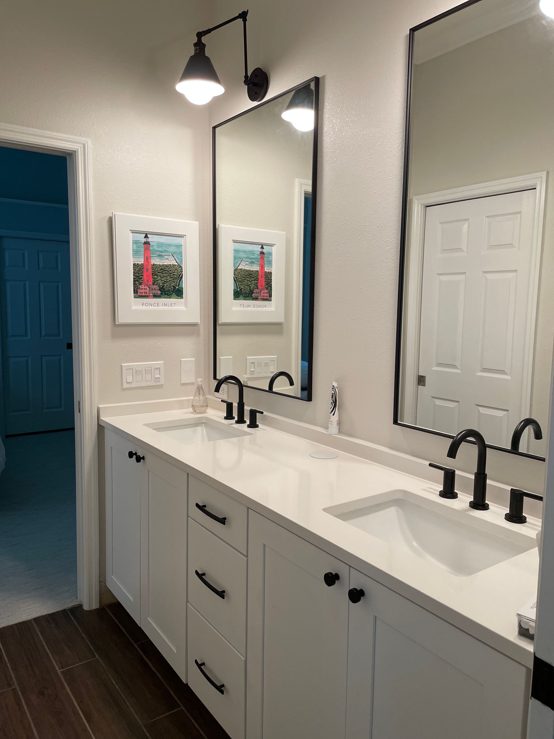 A bathroom with two sinks and two mirrors.