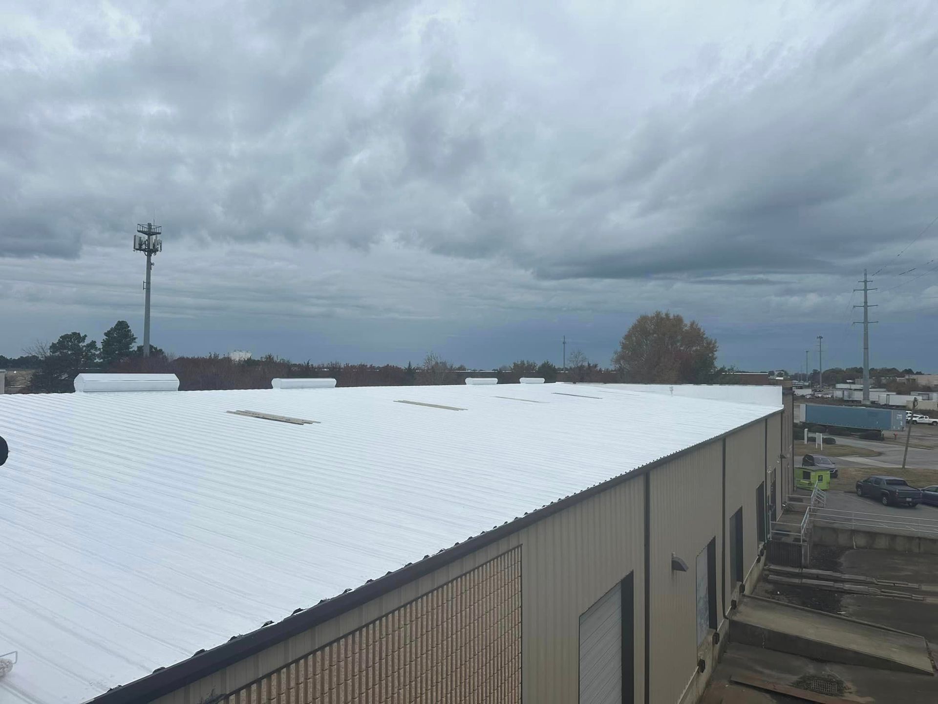 a large building with a new white roof.