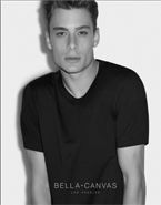 A black and white photo of a young man wearing a black t-shirt.