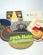 a bunch of coasters are sitting on top of each other on a table