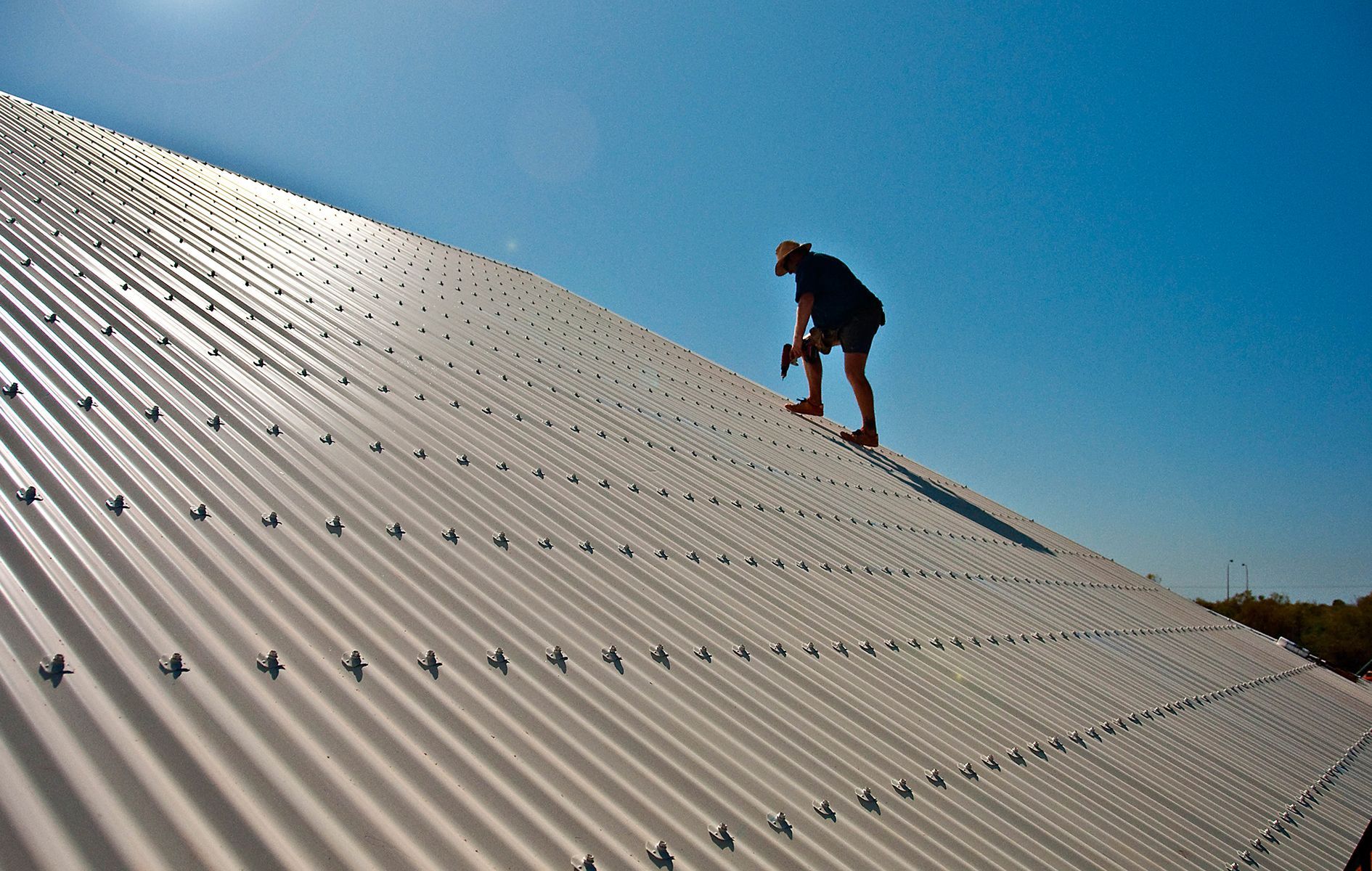 A man is working on the roof of a building