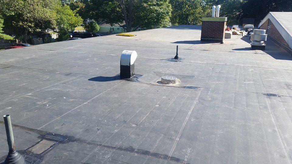 The roof of a building with a chimney on it.