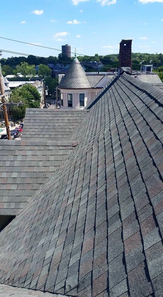 An aerial view of a roof with a city in the background.