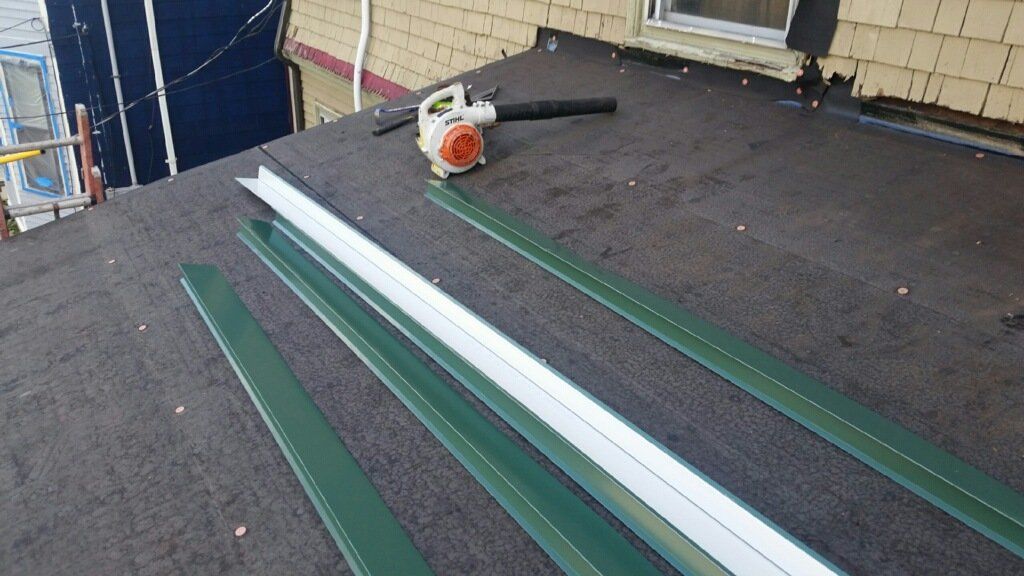 A blower is sitting on the roof of a house.